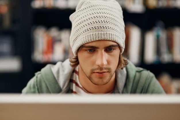 A photo of Edward Snowden sitting in front of a computer, with a concerned expression on his face. The background is blurred to focus on Snowden's face and the laptop screen.