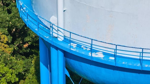A serene image of a water treatment facility with cylindrical tanks and pipes against a backdrop of lush greenery and a calm, reflective body of water. The facility appears modern and well-maintained, with a focus on environmental responsibility and sustainable water management.